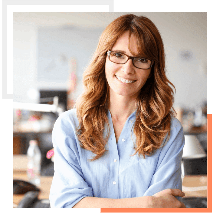 A woman with glasses is smiling for the camera.