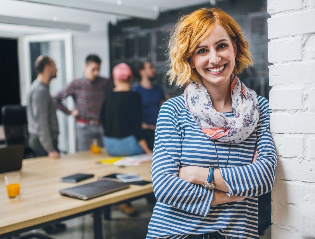 A woman standing in front of other people.